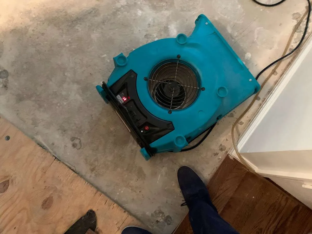 Air mover drying subfloor during Leak Detection & Repair in Menomonee Falls